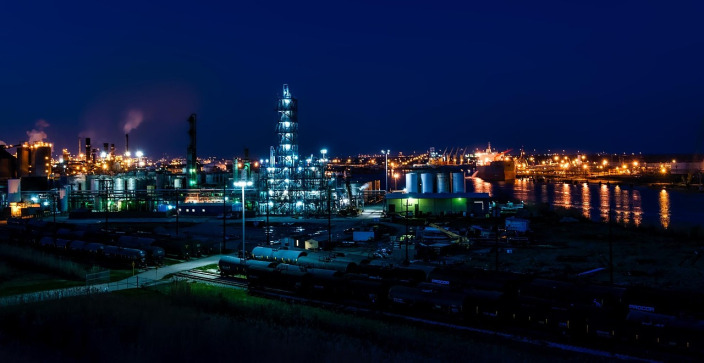 Refinery storage tanks at night